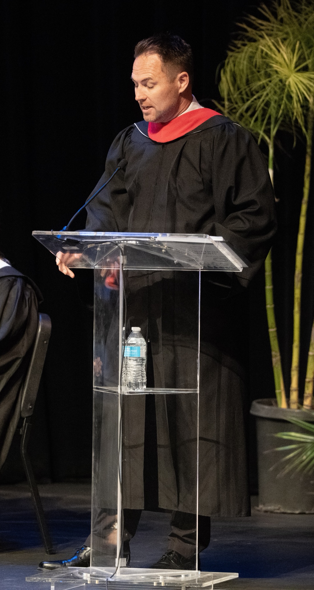 Todd Frazier speaking at a podium during a PYLUSD graduation ceremony